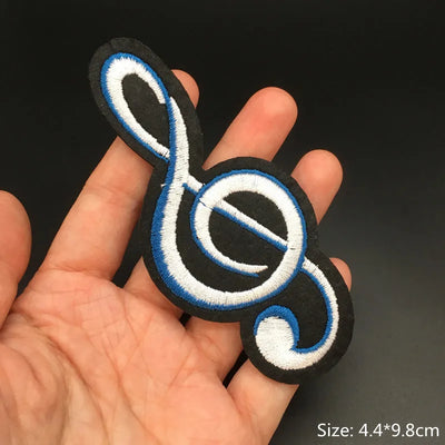 Music note patch held in a hand with a dark background