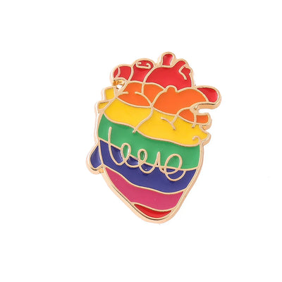 Rainbow heart-shaped pin with anatomical heart design on a white background