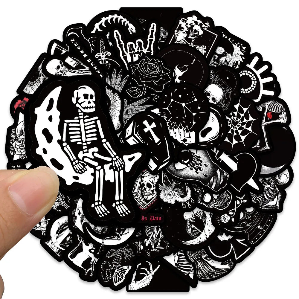 Circular sticker with black and white designs including skeletons and skulls held by a hand.