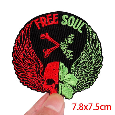Patch with 'Free Soul' text, wings, and a red triangle held by a hand on a white background.
