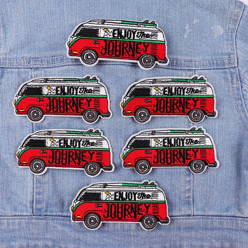 Set of 'Enjoy the Journey' van patches on a denim jacket.