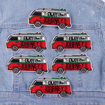 Set of 'Enjoy the Journey' van patches on a denim jacket.