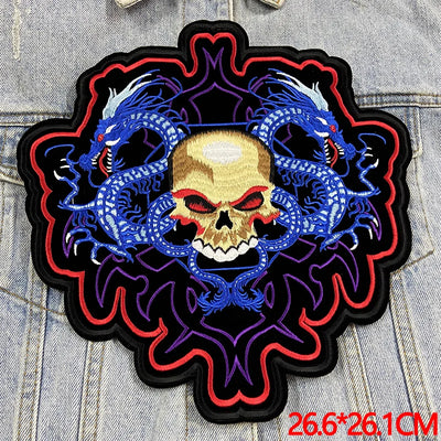 Embroidered patch with skull and dragons design on denim fabric