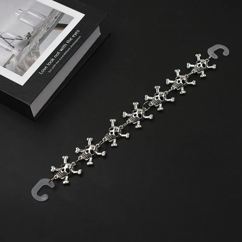 Silver chain for crocs with skull designs on a black background