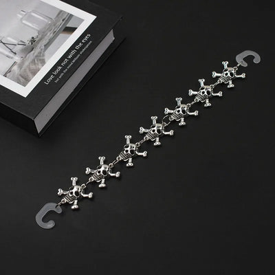 Silver chain for crocs with skull designs on a black background