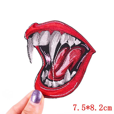 Red mouth-shaped patch held by a hand with a white background