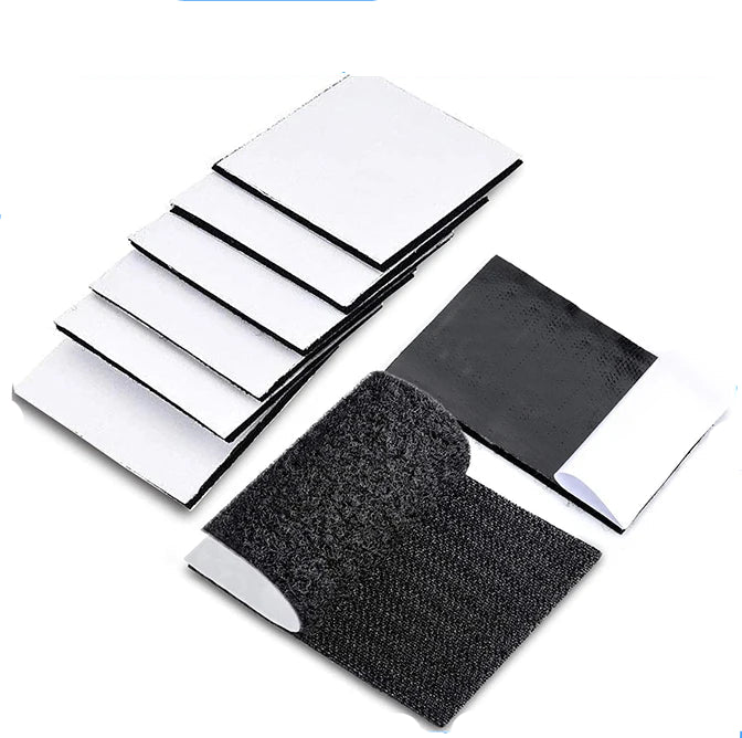 Set of Black adhesive Velcro patches on a white background