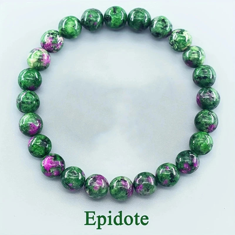 Green and purple beaded bracelet on a white background with &