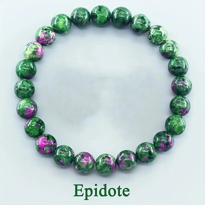 Green and purple beaded bracelet on a white background with &