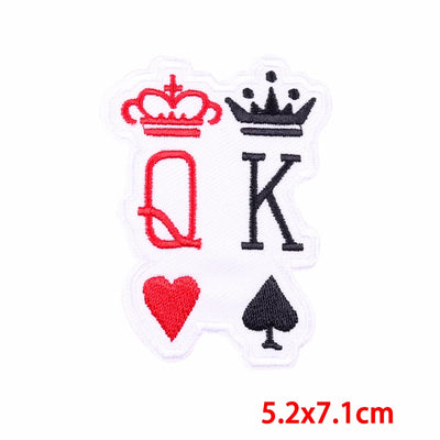 Embroidered patch with 'Q' and 'K' symbols on a white background