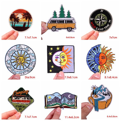 Collection of various patches with different designs and sizes held by hands on a white background.