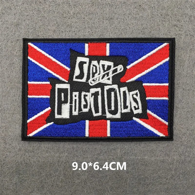 Patch with 'Sex Pistols' text on a Union Jack background, size 9.0*6.4CM, on a gray surface.