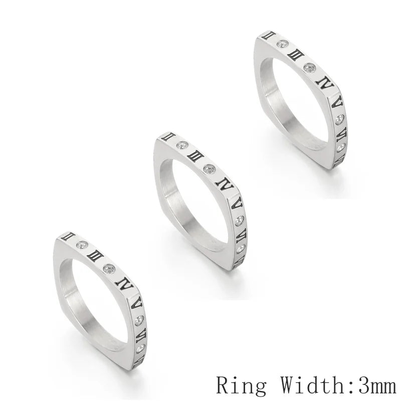 Three silver rings with Roman numeral accents on a white background
