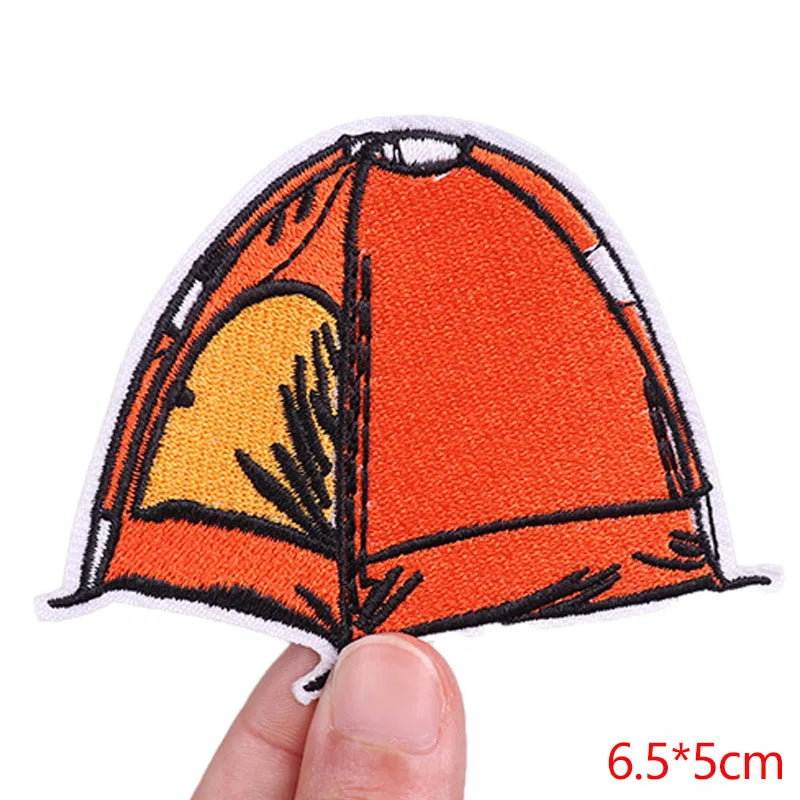 Embroidered patch of a tent held by a hand with dimensions displayed.