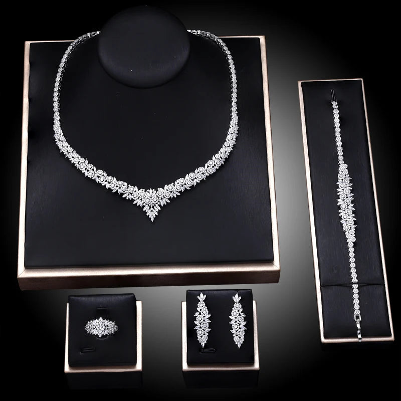 Jewelry set including necklace, bracelet, earrings, and ring on a black display cards