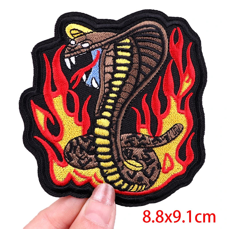 Snake with flames design patch held by a hand, size 8.8x9.1cm