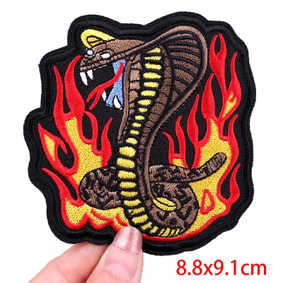 Snake with flames design patch held by a hand, size 8.8x9.1cm