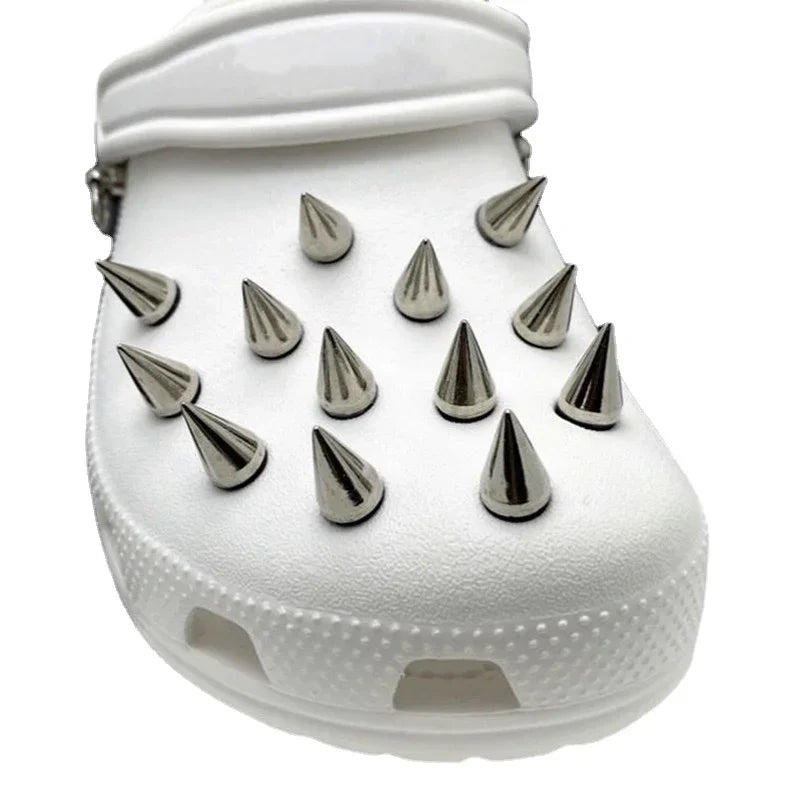 White clog shoe with silver spikes on a white background