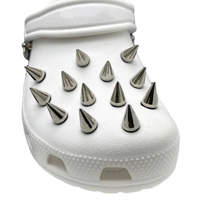 White clog shoe with silver spikes on a white background