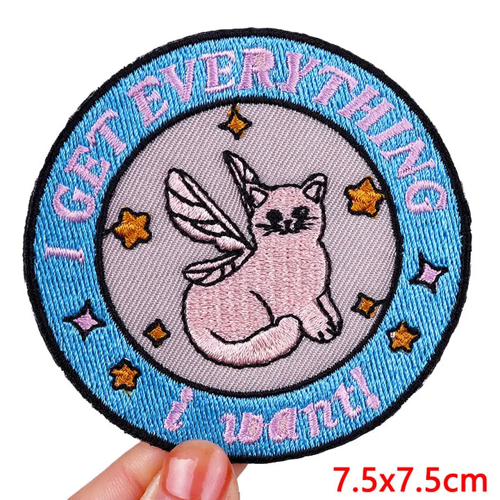 Circular patch with a cat unicorn design and text &