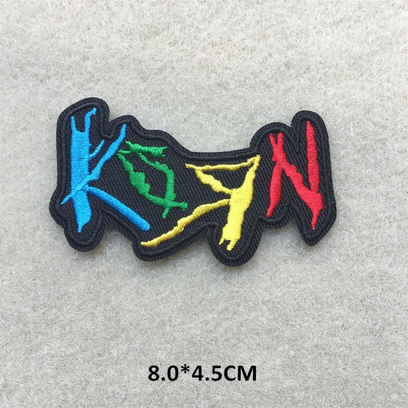 Colorful embroidered patch with text on a gray background