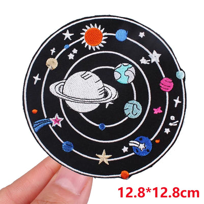 Circular patch with solar system design held by a hand, showing size 12.8*12.8cm.