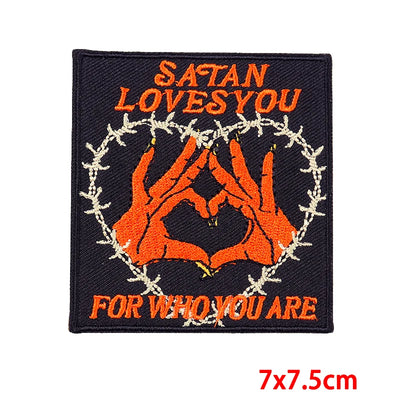 Patch with 'Satan Loves You For Who You Are' text and design on a black background