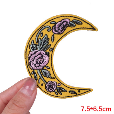 Floral crescent moon patch held by a hand with dimensions displayed.