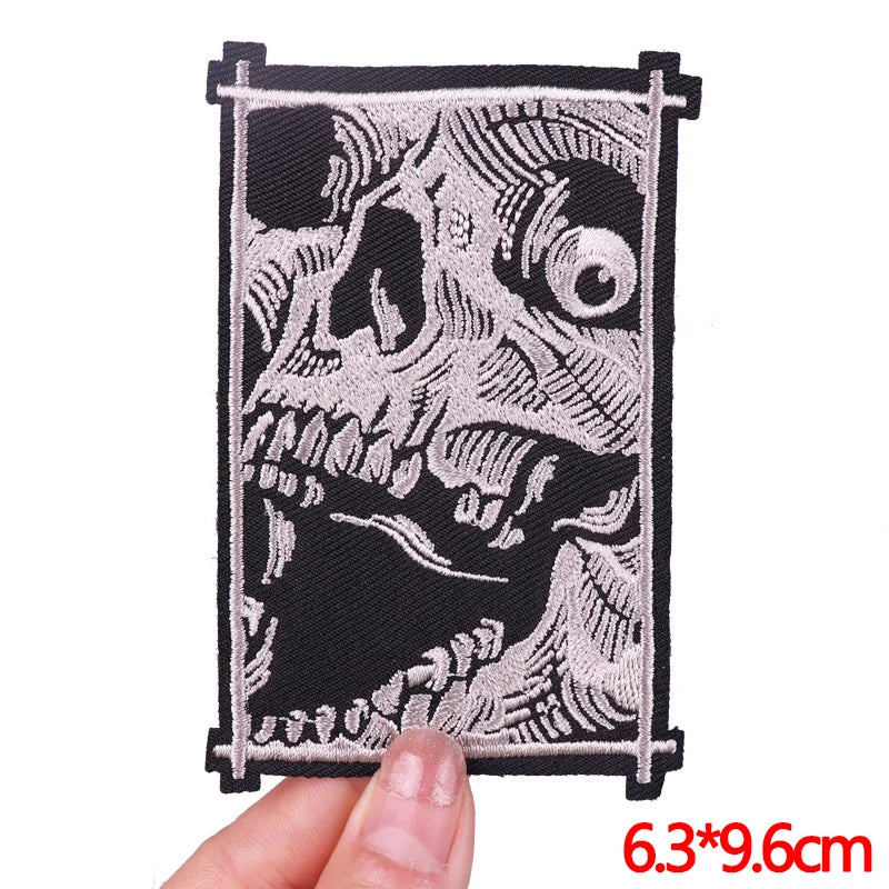 Decorative patch with intricate design held by a hand, size indicated.