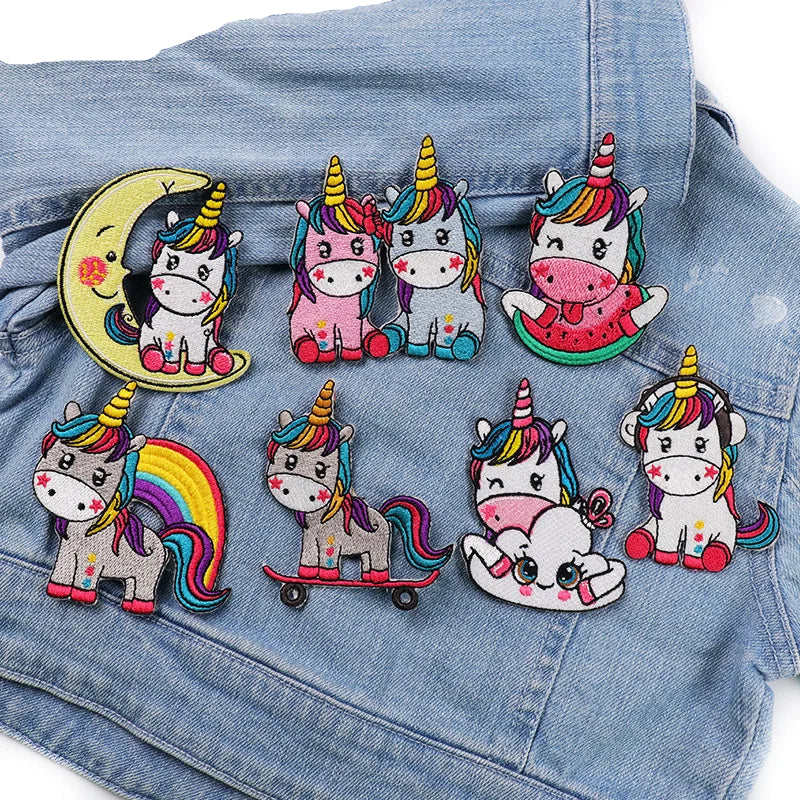 Colorful unicorn patches on a denim background