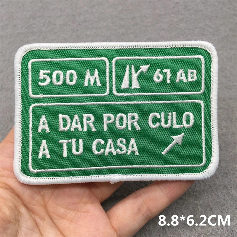 Embroidered patch with text and symbols on a gray background