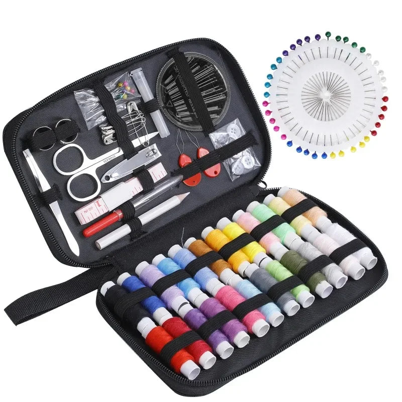 Sewing kit with colorful thread spools, pins, and tools in a black case.