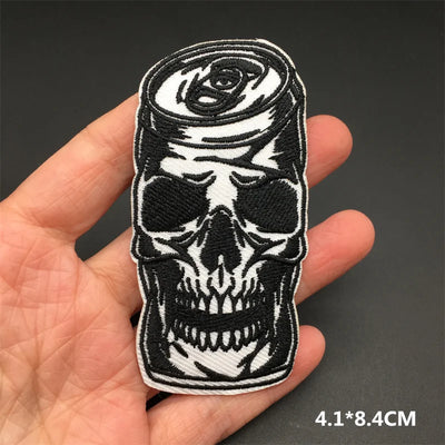 Skull and rose patch held in a hand with a dark background