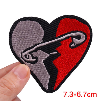 Heart-shaped patch with red and gray design held by a hand, size 7.3*6.7cm