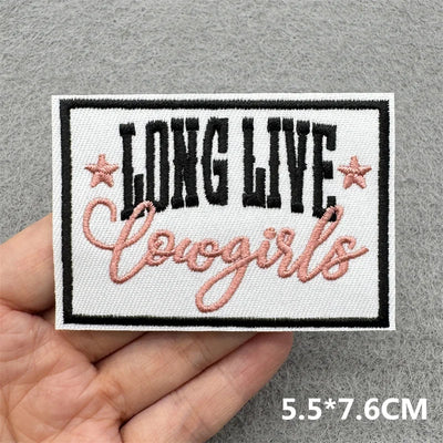 Embroidered patch with 'LONG LIVE Cowgirls' text held by a hand on a gray background