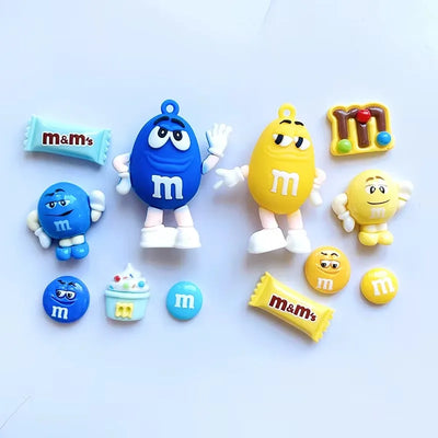 Colorful M&M character figurines on a light blue background