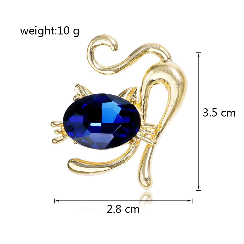 Gold cat brooch with a blue gemstone, showing weight and dimensions on a white background.