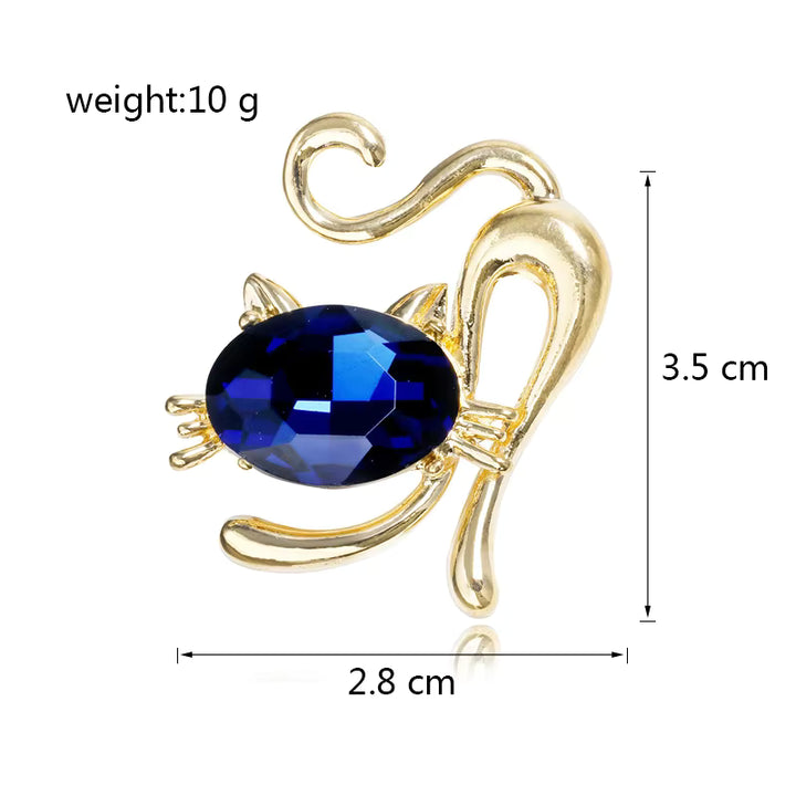 Gold cat brooch with a blue gemstone, showing weight and dimensions on a white background.