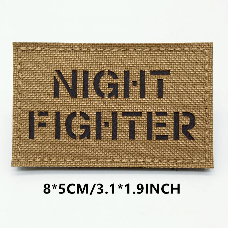 Rectangular patch with 'NIGHT FIGHTER' text on a brown background