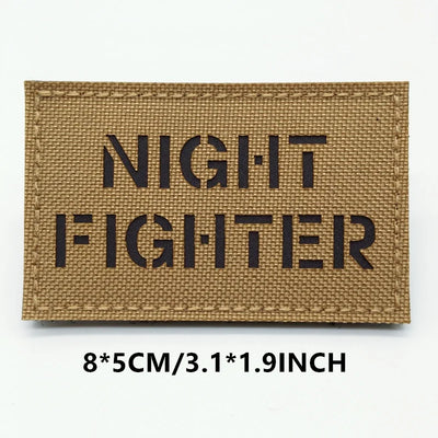 Rectangular patch with 'NIGHT FIGHTER' text on a brown background