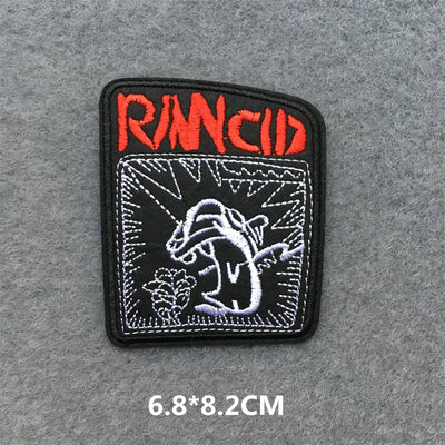 Embroidered patch with 'Rancid' logo on a gray background