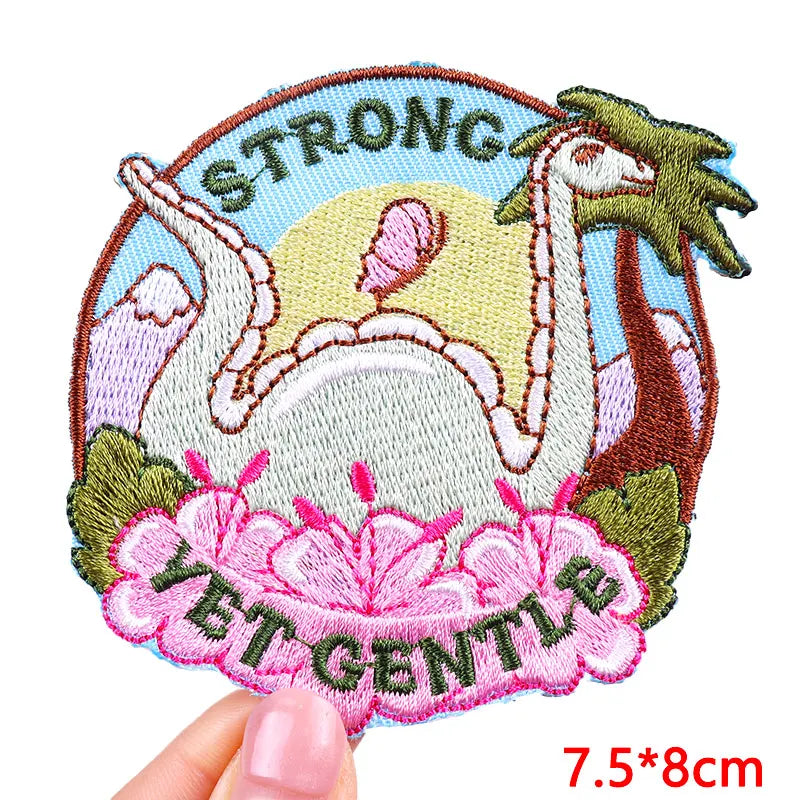 Embroidered patch with a dragon design, 'STRONG LET GENTLE' text, and floral elements.