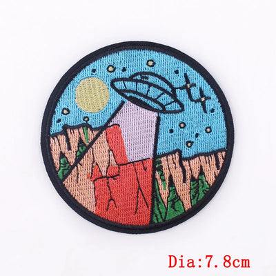 Round patch with UFO design on a white background
