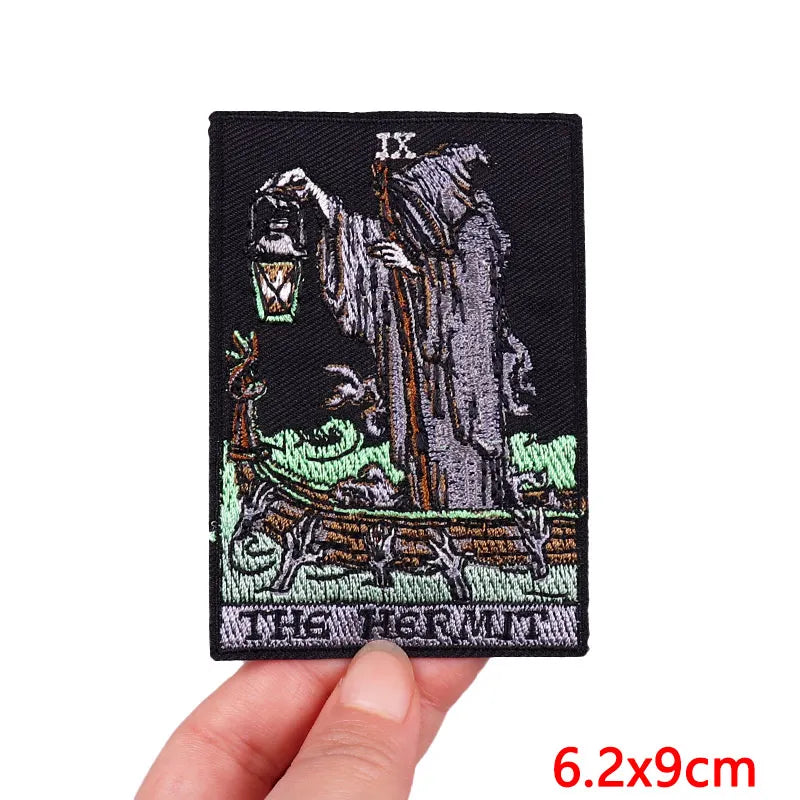 Embroidered patch with skeleton design held by a hand on a white background