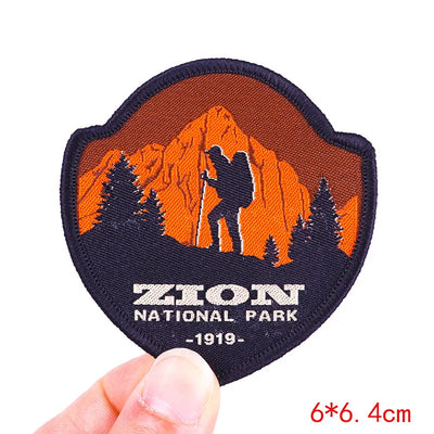 Patch of Zion National Park with a silhouette of a hiker and mountain.