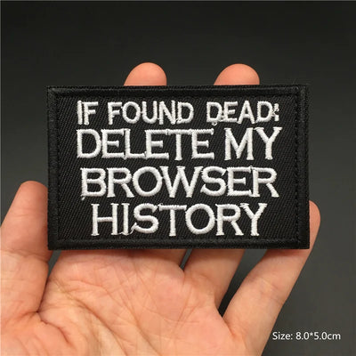 Embroidered patch with text 'IF FOUND DEAD: DELETE MY BROWSER HISTORY' held in a hand against a dark background.