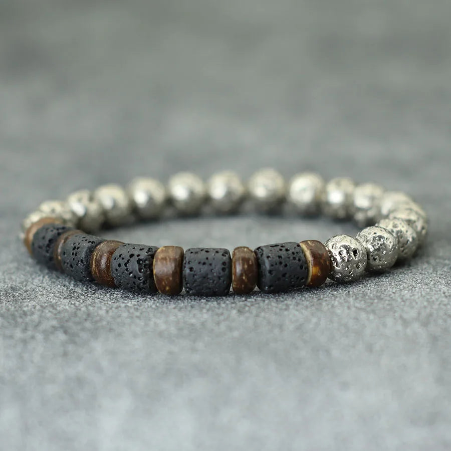 Beaded bracelet with silver, black, and brown beads on a gray background