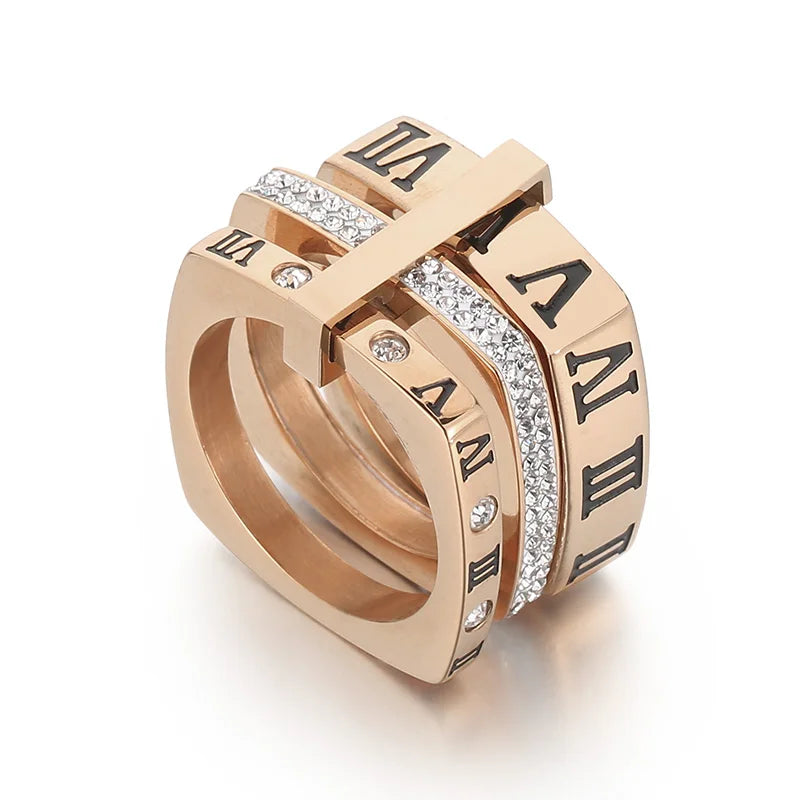 Rose gold ring with Roman numeral design on a white background
