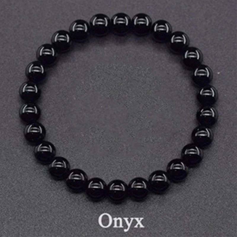 Black onyx beaded bracelet on a gray background