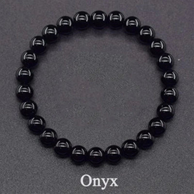 Black onyx beaded bracelet on a gray background